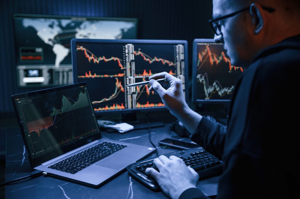 Person analyzing forex vs stock market charts on a computer screen in April 2025