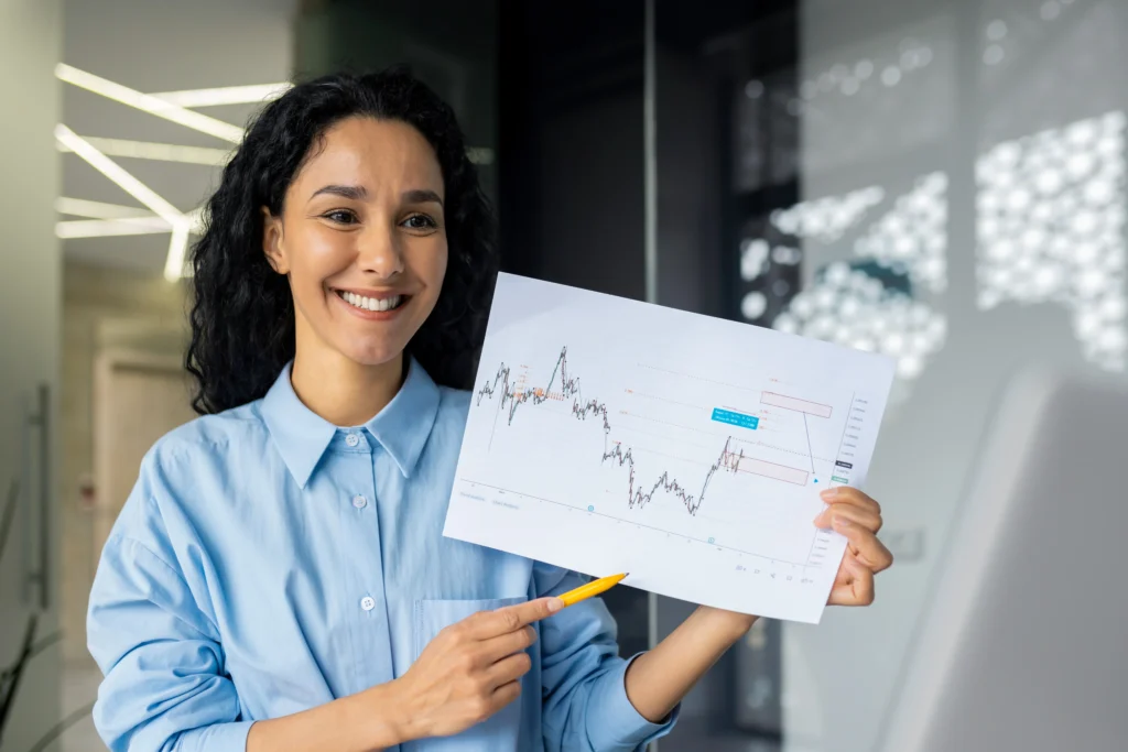 Businesswoman outlines Trading Success Blueprint while engaging with team in a virtual meeting.