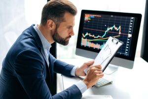 Investor reviewing forex performance using a regulated Forex managed account service for safe and transparent trading.