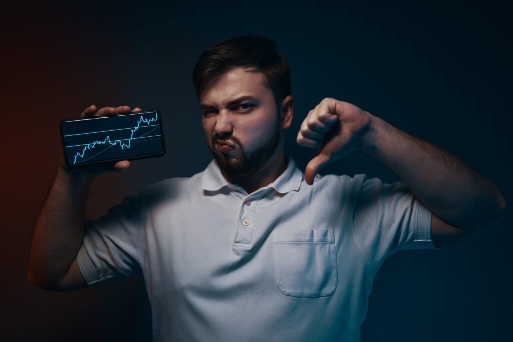 Man pointing downward, illustrating a simplified Off-Screen Forex Trading approach designed for traders with limited screen time.