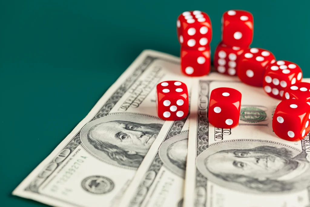 Dices rolling on American dollar bills show the mix of risk and decision-making in forex trading and currency markets.