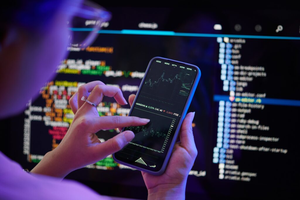 Trader using hybrid trading strategy with charts and AI tools on screen