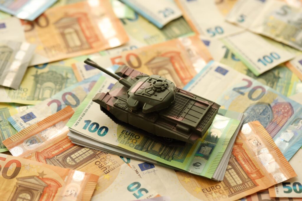 Tank on euro bills representing currency wars and competitive devaluation in forex markets.