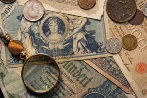 Old notes and coins showing the history of forex trading and global currency exchange.