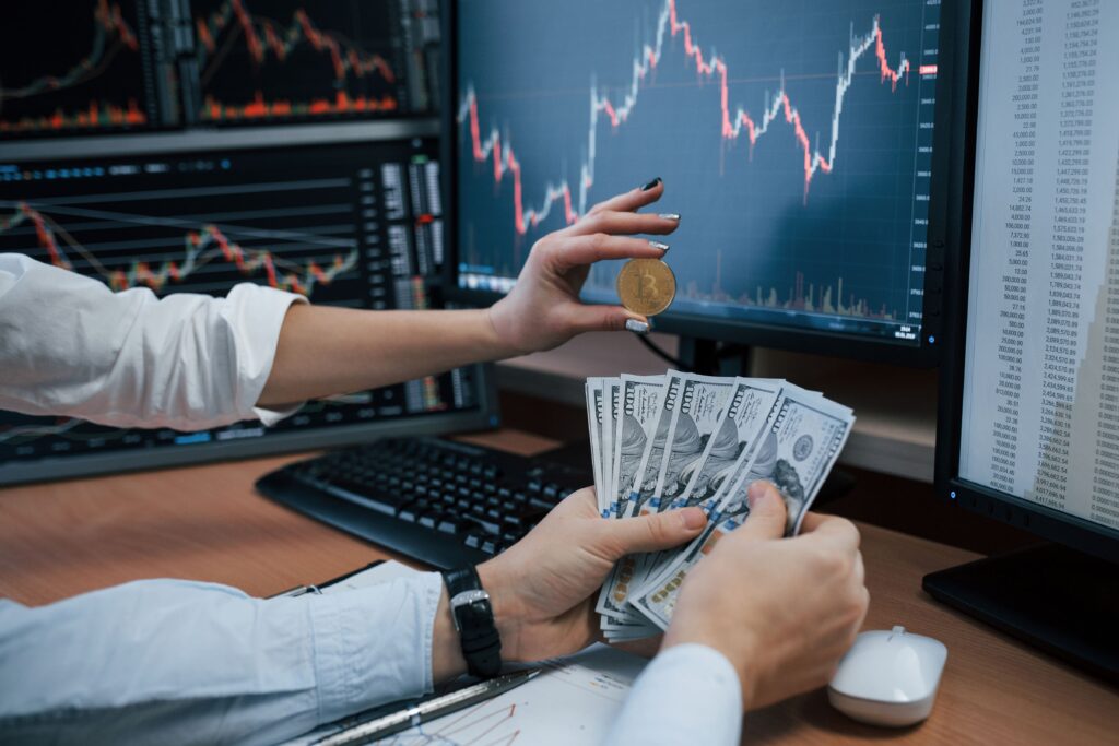 Smart Money Concepts in Forex illustrated by traders holding Bitcoin and cash in front of forex charts and market data.