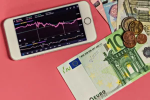 Smart Money AI Pip Tracking on phone screen with forex chart and euro currency notes