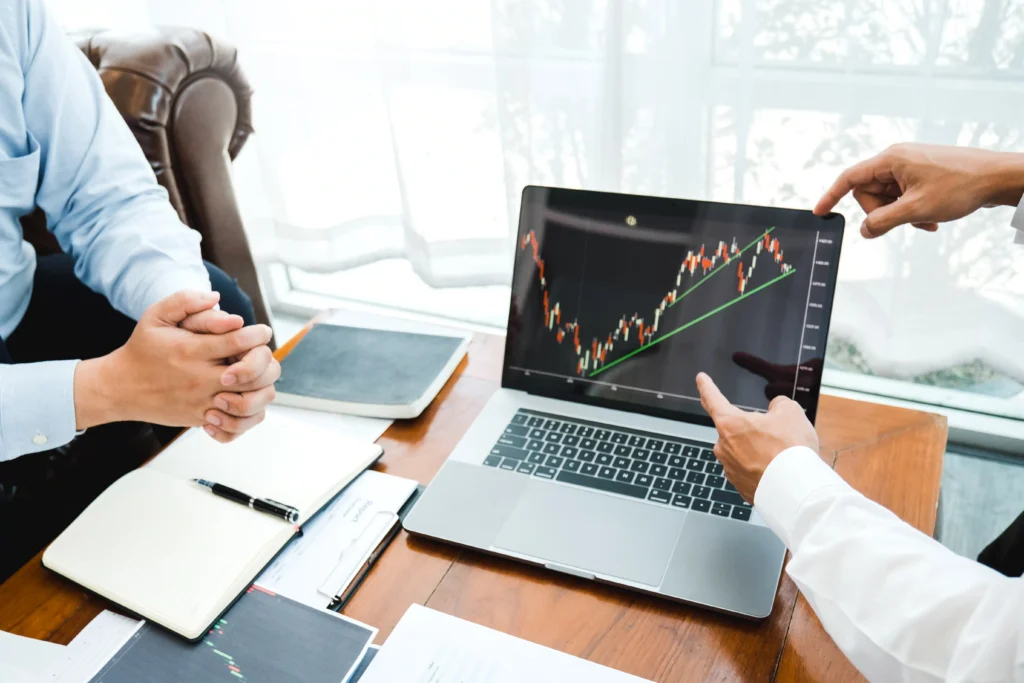Business team reviews Double Bottom Pattern on trading chart for bullish reversal analysis