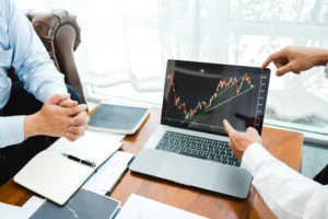 Business team reviews Double Bottom Pattern on trading chart for bullish reversal analysis