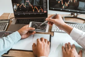 Double top pattern analysis on computer screens and mobile device by traders.