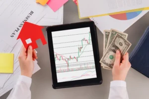 Tablet with trading chart, person holding cash and house figure, concept of Can Forex Trading Really Make You Rich