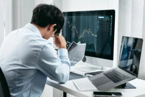 Symmetrical Triangle Pattern analysis on trading screens with a focused investor.