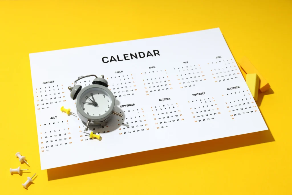 Economic Calendar for Traders with clock and push pins on a calendar page for forex market planning