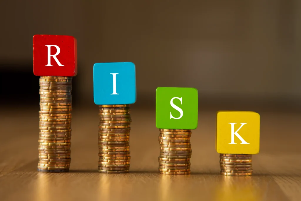 Stacked coins with RISK blocks illustrating Multi-Pair Forex Risk Management in forex trading.