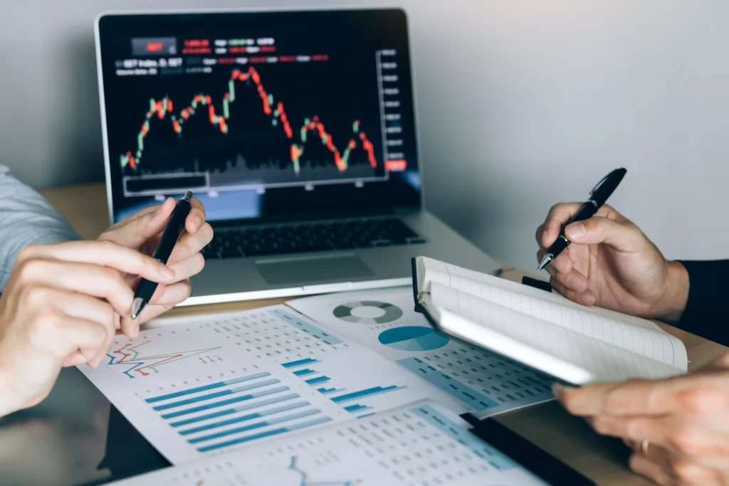 Investors analyzing charts and taking notes for diversification strategy
