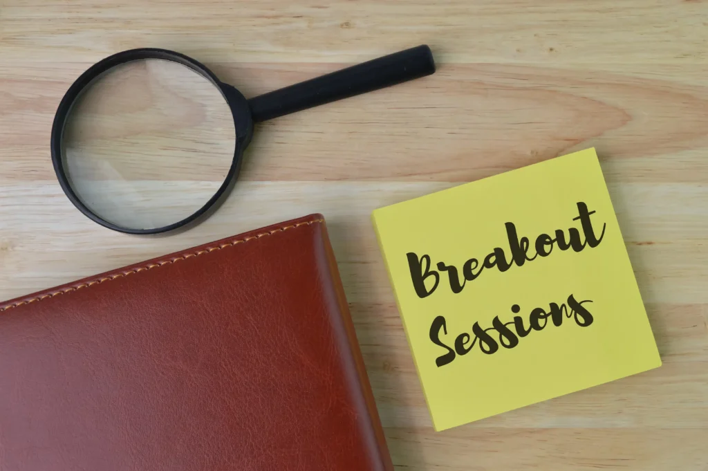 Magnifying glass, leather notebook, and sticky note with Breakout Sessions text for Social Media Alerts in Breakout Trading.