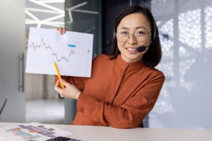 Woman presenting a forex trading chart and discussing leverage in forex during a webinar.