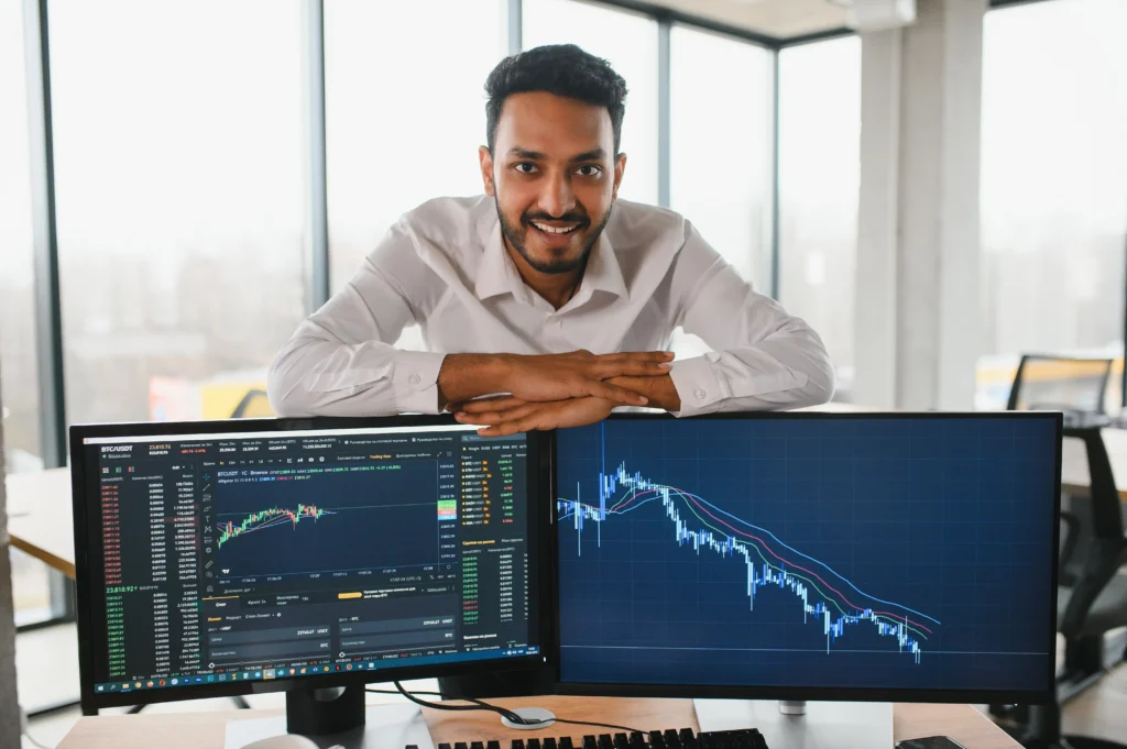 Habits of Successful Forex Traders working at a desk with trading charts on computer screens.