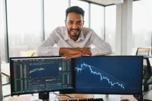 Habits of Successful Forex Traders working at a desk with trading charts on computer screens.