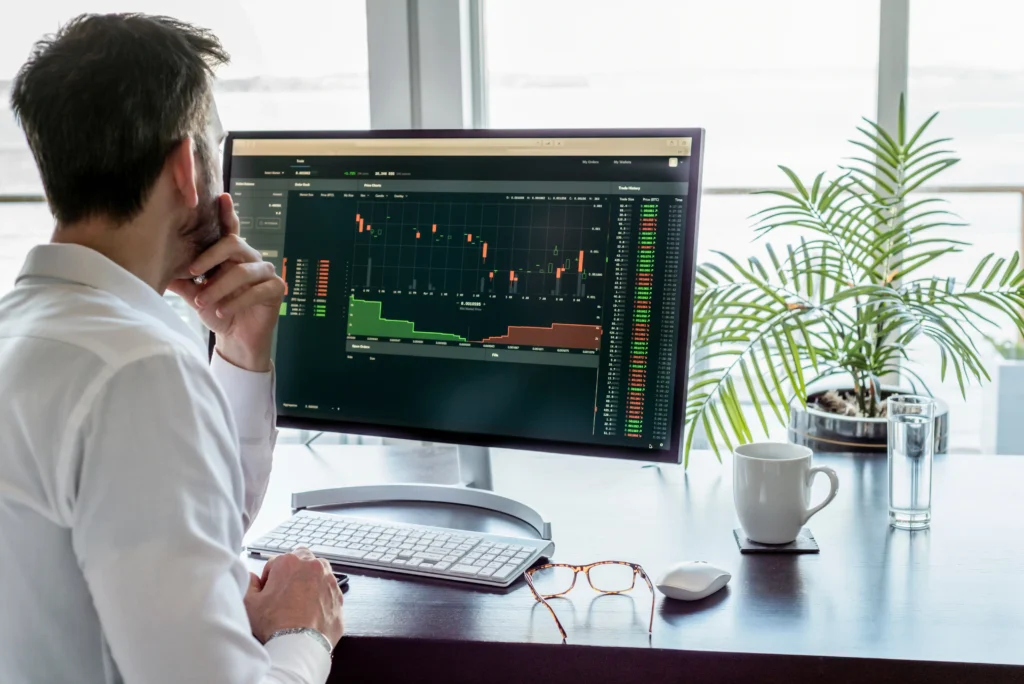 Trader studying top candlestick timeframes on a computer screen for trading analysis in 2025.