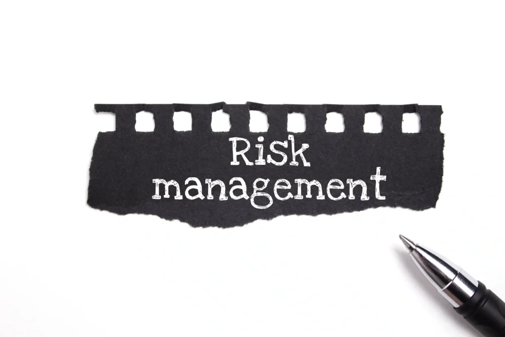 Risk management sign with pen, illustrating Forex Risk Management Strategies.