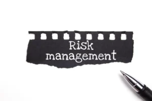 Risk management sign with pen, illustrating Forex Risk Management Strategies.