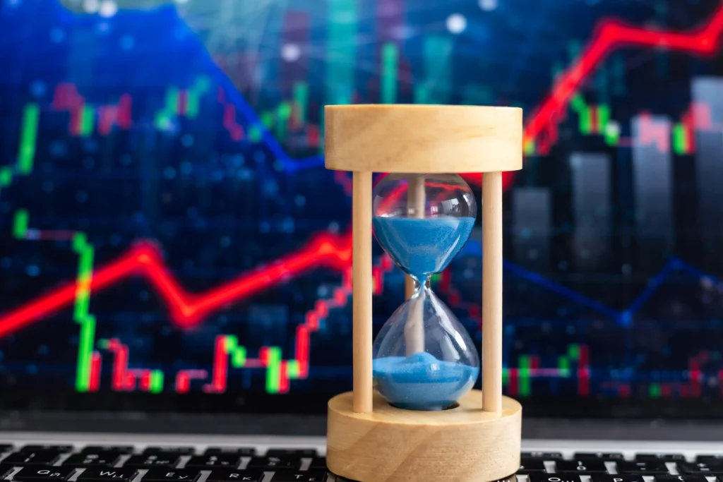 Hourglass and trading chart representing Time Segmented Volume analysis.