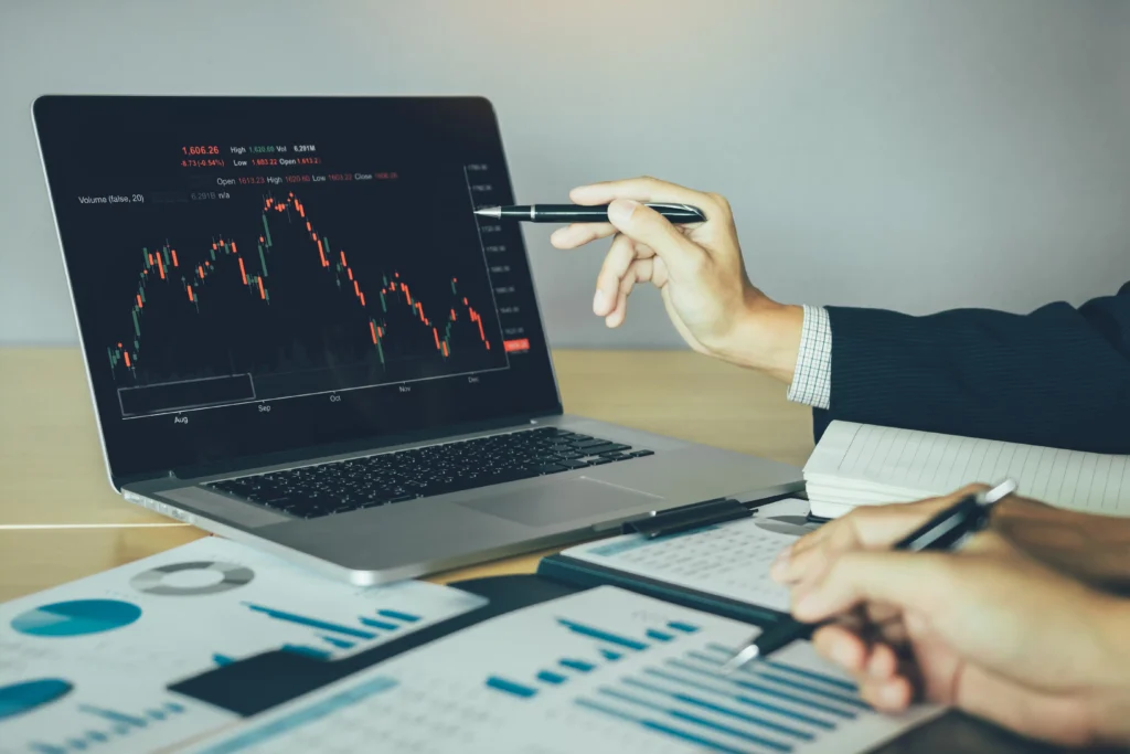 Investors examining a wedge pattern in trading on a candlestick chart for technical analysis.