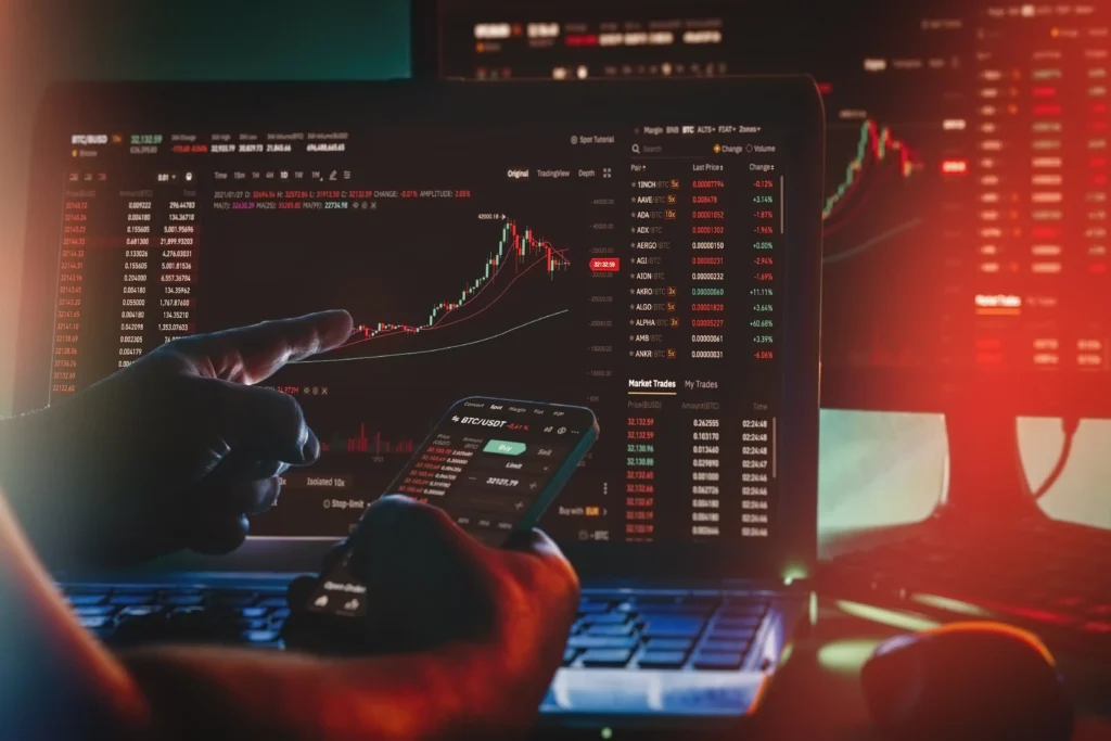 Scalping vs Day Trading strategies displayed on laptop and mobile screens with live cryptocurrency price charts and market data.