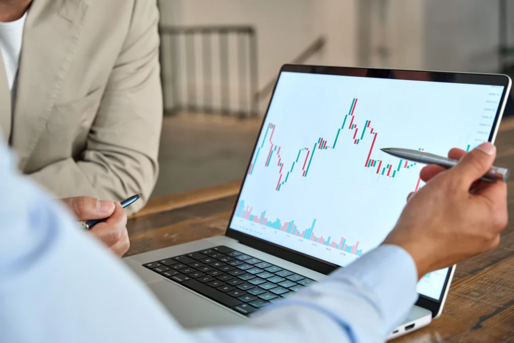 Breakout vs Breakdown pattern chart analysis on laptop screen during market discussion.