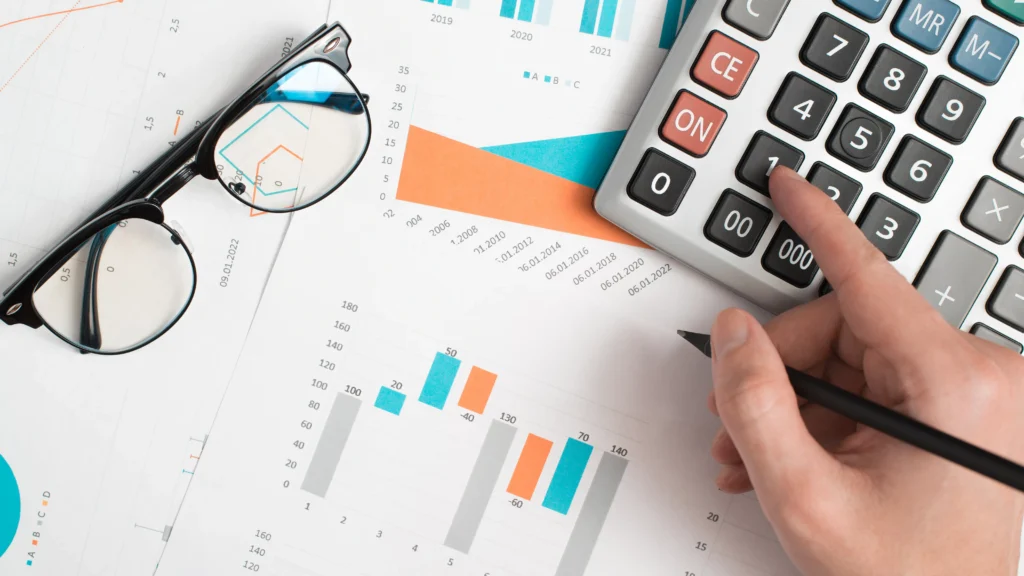 Volume Weighted Average Price calculation with financial charts, graphs, and a calculator on a desk in 2025.