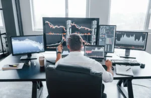 Trader analyzing charts and multiple monitors while applying backtesting trading strategies for accuracy in forex trading 2025