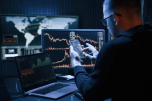 Forex trader analyzing market structure forex charts on multiple screens and smartphone in 2025 with live candlestick patterns.