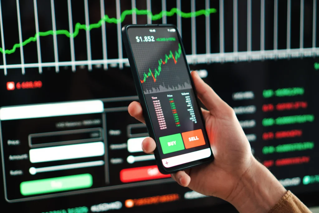 Exchange Types on mobile trading app showing live crypto and stock market charts with buy and sell options.