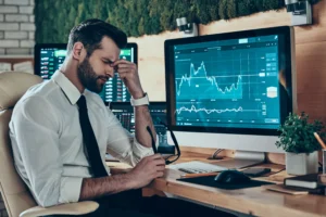 Trader stressed after handling first losses in trading on a live forex account