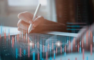 A trader analyzing digital charts on a tablet, symbolizing Mid-Year Market Update 2025 and global financial trends.