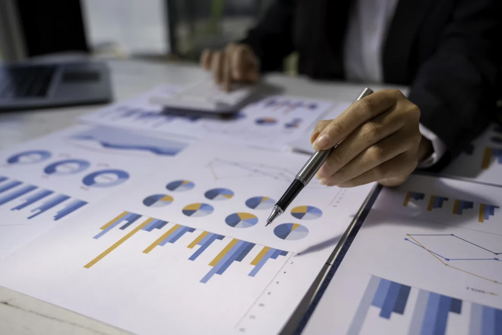 Businesswoman analyzing financial charts and graphs for Post-Trade Cost Analysis to measure execution performance and reduce hidden trading costs in 2025.