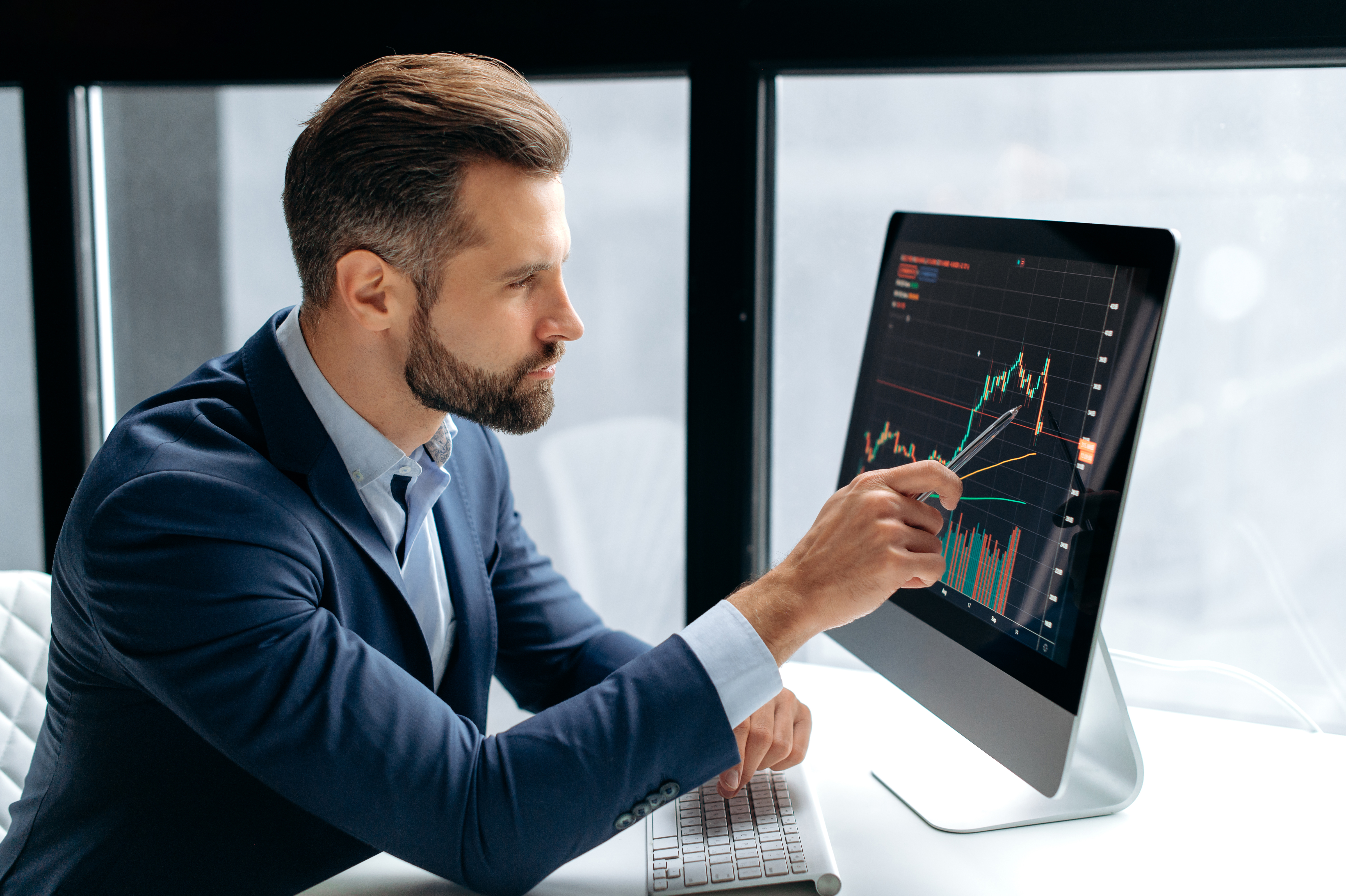 Professional trader analyzing candlestick chart on computer for Morning and Evening Star Patterns.