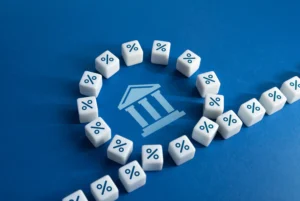 Interest rates impact on currency values concept showing central bank and percentage icons symbolizing monetary policy decisions.