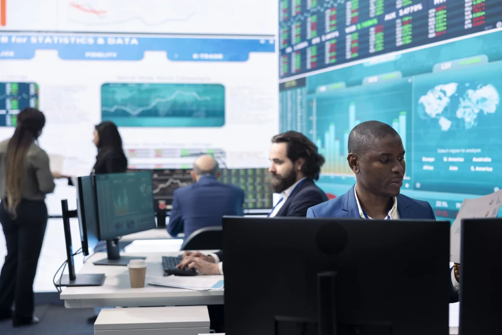 Traders working at electronic trading venues analyzing live market data on Multilateral Trading Facilities screens to ensure transparency and liquidity.