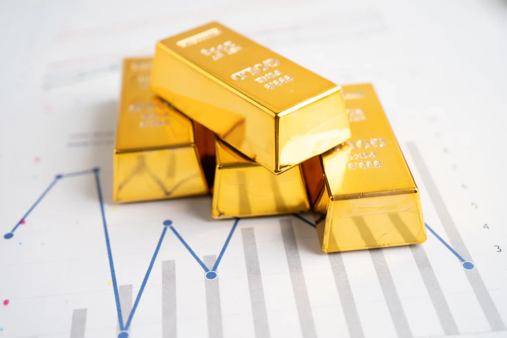 Gold bars stacked on financial chart symbolizing the Gold Bubble 2025 market correction warning.