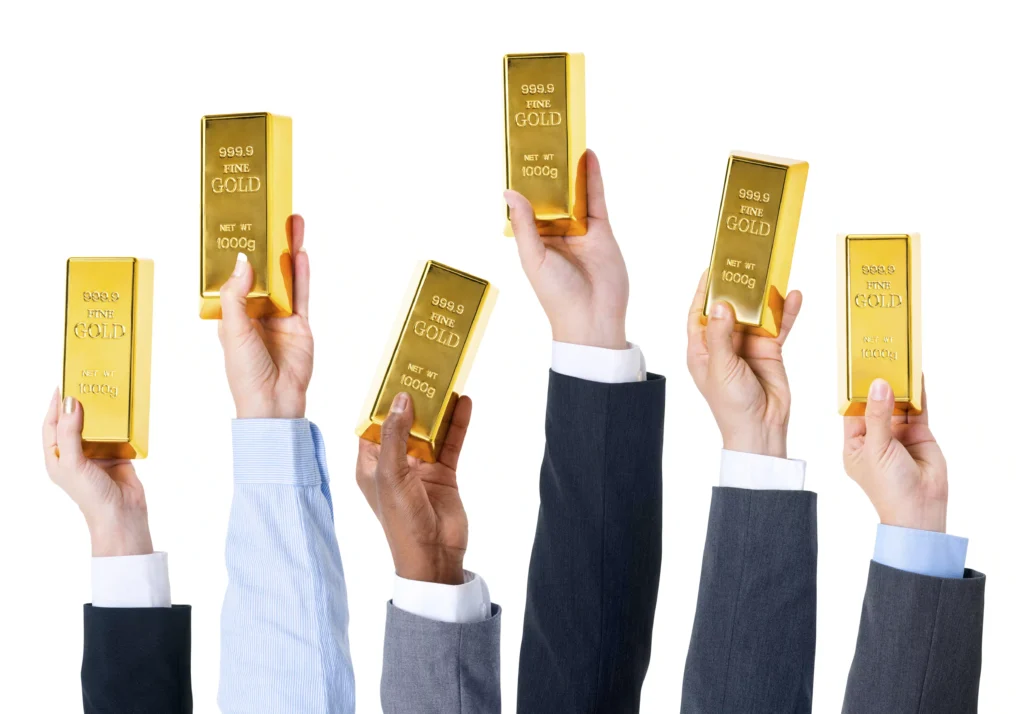 Hands of traders holding gold bars symbolizing confidence and success in global gold trading strategies