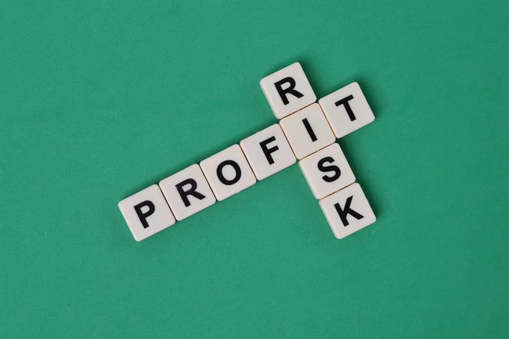 Scrabble letters spelling profit and risk symbolizing balance in profitable and risk-free options trading.