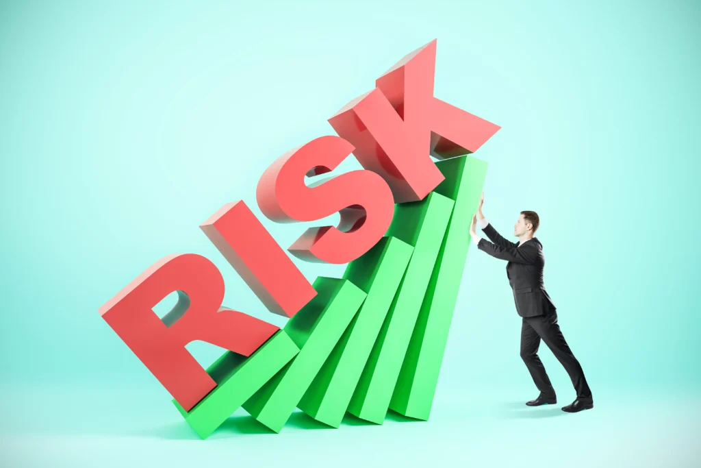 Businessman stabilizing the word RISK representing Systematic Risk in financial markets