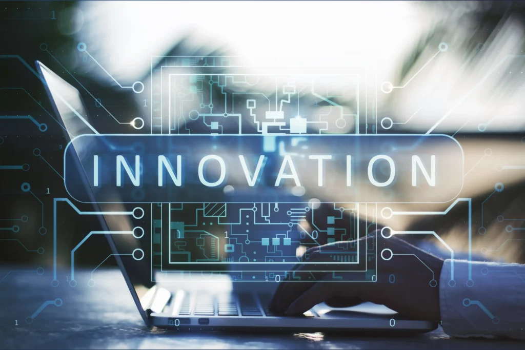 Person typing on a laptop with the word “Innovation” displayed digitally, symbolizing technological transformation in global trade and forex markets.
