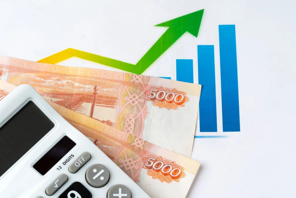 Green upward arrow, blue bar chart, calculator, and Russian ruble notes representing inflation trends and CPI vs PPI impact.