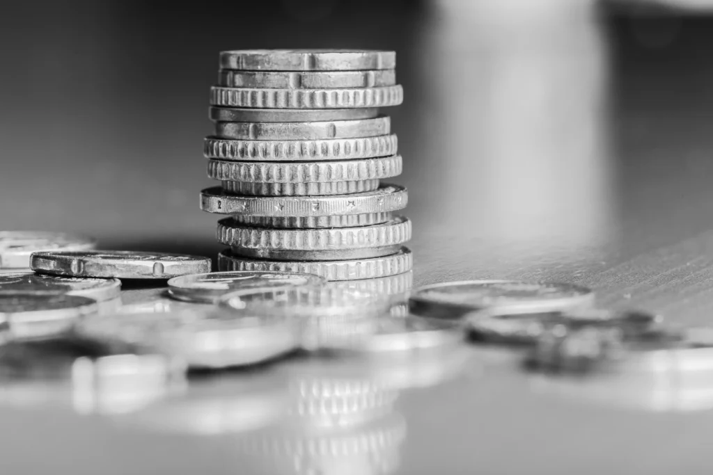 Stack of silver coins in grayscale representing Silver Price Movements 2025 and global market volatility.
