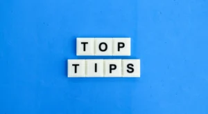 Image showing white letter tiles spelling “Top Tips” on a blue background, used for the article Top 10 Backtesting Tips.