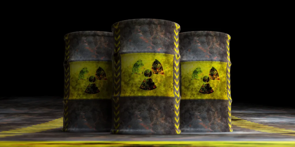 Rusty uranium barrels with radiation symbols representing nuclear energy and uranium investment.