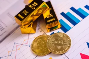 Gold bars and Bitcoin coins placed on financial charts showing market data and price movements.