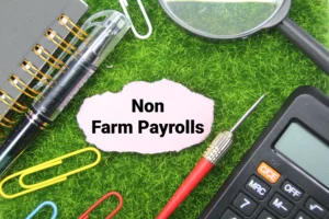Non-Farm Payroll concept displayed with stationery, calculator, and analysis tools on a desk, representing economic job data.